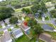 An aerial view reveals a home with a screened-in pool, mature trees, and a well-kept lawn at 1715 Larabie Ct, Brandon, FL 33511