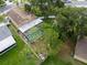Aerial view of the property with pool, partial fence, and some trees at 1715 Larabie Ct, Brandon, FL 33511