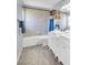 Bathroom featuring double sinks, framed mirrors, and bathtub with shower and tile surround at 1715 Larabie Ct, Brandon, FL 33511