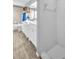 Bright bathroom featuring double sinks, tub with shower, and a glass enclosed shower at 1715 Larabie Ct, Brandon, FL 33511