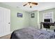 Bedroom featuring neutral green walls, a ceiling fan and a dedicated desk workspace at 1715 Larabie Ct, Brandon, FL 33511