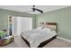 A bedroom featuring a queen bed, carpet, modern ceiling fan, and sliding glass doors at 1715 Larabie Ct, Brandon, FL 33511
