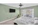 A bedroom featuring a queen bed, carpet, modern ceiling fan, and sliding glass doors leading to a pool at 1715 Larabie Ct, Brandon, FL 33511