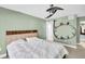 A bedroom featuring a queen bed, carpet, modern ceiling fan, and modern black bookshelf at 1715 Larabie Ct, Brandon, FL 33511