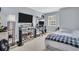 Bedroom featuring a built in desk and work area, with a neatly made bed and wall mounted TV at 1715 Larabie Ct, Brandon, FL 33511