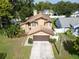 Aerial view of a two story house with a brown roof and garage at 1715 Larabie Ct, Brandon, FL 33511