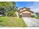 Charming two-story home featuring a well-manicured lawn and mature landscaping at 1715 Larabie Ct, Brandon, FL 33511