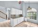 Well-lit kitchen area with white cabinets, stone countertops, and a window with natural light at 1715 Larabie Ct, Brandon, FL 33511