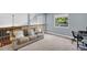 Cozy loft area showcases plush sofa, natural lighting, and a wooden railing overlooking the downstairs space at 1715 Larabie Ct, Brandon, FL 33511