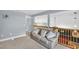 Open loft area displays a comfortable sofa and overlooks the living area with a wooden railing at 1715 Larabie Ct, Brandon, FL 33511