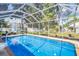 Screened-in pool with outdoor seating, lounge chairs, and an umbrella at 1715 Larabie Ct, Brandon, FL 33511