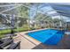 Backyard pool area featuring outdoor seating and an umbrella at 1715 Larabie Ct, Brandon, FL 33511