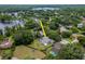 Aerial view of home with a pool, fenced yard, and proximity to lake and lush greenery at 18004 Clear Lake Dr, Lutz, FL 33548