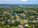 Aerial view of the property and neighborhood, showcasing its location and proximity to the water at 18004 Clear Lake Dr, Lutz, FL 33548