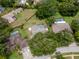Aerial view of the property showcasing the pool, fenced yard, and surrounding neighborhood at 18004 Clear Lake Dr, Lutz, FL 33548