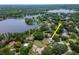 Aerial view of the property and neighborhood, showcasing its location and proximity to the water at 18004 Clear Lake Dr, Lutz, FL 33548