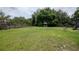 Expansive backyard with mature trees and a charming gazebo, perfect for relaxing and entertaining at 18004 Clear Lake Dr, Lutz, FL 33548