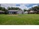 Expansive backyard with screened-in pool, mature trees, and plenty of space for outdoor activities at 18004 Clear Lake Dr, Lutz, FL 33548
