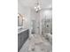 Beautiful bathroom with dual vanity sinks, marble floors, and a glass-enclosed shower at 18004 Clear Lake Dr, Lutz, FL 33548
