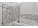 Luxurious bathroom with a glass-enclosed shower and separate jetted tub at 18004 Clear Lake Dr, Lutz, FL 33548