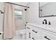 Bright bathroom featuring updated vanity, fixtures, and a shower-tub combination at 18004 Clear Lake Dr, Lutz, FL 33548
