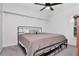 Cozy bedroom with a modern iron bed frame and overhead shelving provides storage at 18004 Clear Lake Dr, Lutz, FL 33548