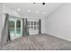 Bright bedroom with plush carpet, plantation shutters, and slider to pool at 18004 Clear Lake Dr, Lutz, FL 33548