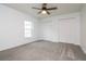 Spacious bedroom with a window and double closets boasts plenty of room at 18004 Clear Lake Dr, Lutz, FL 33548