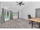 Light-filled bedroom with neutral carpet and a sliding glass door to the pool at 18004 Clear Lake Dr, Lutz, FL 33548