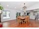 Bright dining room featuring hardwood floors, a rustic wood table, and modern lighting at 18004 Clear Lake Dr, Lutz, FL 33548