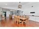 Open dining room with hardwood floors, modern lighting, and access to the kitchen at 18004 Clear Lake Dr, Lutz, FL 33548