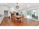 Dining room featuring hardwood floors, a large table, and views of the pool at 18004 Clear Lake Dr, Lutz, FL 33548