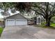 Well-maintained single-Gathering home featuring a three-car garage and mature trees in a peaceful residential setting at 18004 Clear Lake Dr, Lutz, FL 33548
