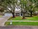 Charming home with mature trees, three car garage, and attractive landscaping at 18004 Clear Lake Dr, Lutz, FL 33548