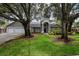 Charming home with well-manicured lawn, mature trees, a 3 car garage and welcoming curb appeal at 18004 Clear Lake Dr, Lutz, FL 33548