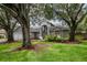 Beautiful home with mature trees, well-manicured lawn, and attractive landscaping at 18004 Clear Lake Dr, Lutz, FL 33548