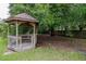 Charming gazebo in a shady backyard, perfect for relaxing and enjoying nature at 18004 Clear Lake Dr, Lutz, FL 33548