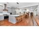 Open kitchen and dining area with a large island, modern appliances, and hardwood flooring at 18004 Clear Lake Dr, Lutz, FL 33548