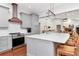 Modern kitchen featuring gray cabinets, stainless steel appliances, and a center island with seating at 18004 Clear Lake Dr, Lutz, FL 33548