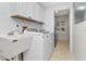 Practical laundry room with washer, dryer, sink and overhead cabinets for storage at 18004 Clear Lake Dr, Lutz, FL 33548
