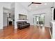 Inviting living room with hardwood floors, neutral decor, and a view into the modern kitchen and outdoor patio at 18004 Clear Lake Dr, Lutz, FL 33548