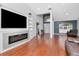 Spacious living room featuring a fireplace, built-in shelving, and hardwood floors, bathed in natural light at 18004 Clear Lake Dr, Lutz, FL 33548