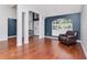 Open-concept living room with hardwood flooring, high ceilings, and views of the entryway and front windows at 18004 Clear Lake Dr, Lutz, FL 33548