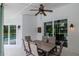 Covered patio with dining table, overlooking pool, offers a great outdoor dining space at 18004 Clear Lake Dr, Lutz, FL 33548