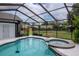 Screened-in pool and spa area is perfect for relaxing and entertaining in the backyard at 18004 Clear Lake Dr, Lutz, FL 33548