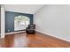 Cozy sitting area with a comfortable armchair, hardwood floors, and a large window at 18004 Clear Lake Dr, Lutz, FL 33548