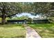 Community tennis court with lush landscaping, offering a great recreational amenity for residents to enjoy at 18004 Clear Lake Dr, Lutz, FL 33548