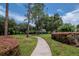 Serene walking path surrounded by manicured landscaping, offering a peaceful escape within the community at 18004 Clear Lake Dr, Lutz, FL 33548