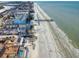 Stunning aerial view of a beachfront property with a pier and pristine white sand at 18610 Gulf Blvd # 607, Indian Shores, FL 33785