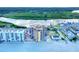 Scenic aerial view of the beachfront condo, pool, and bay with a bridge, highlighting waterfront living at 18610 Gulf Blvd # 607, Indian Shores, FL 33785